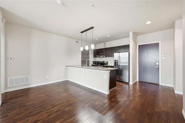 a kitchen with a refrigerator and white cabinets