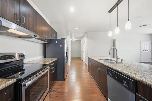 a kitchen with a sink and a stove top oven