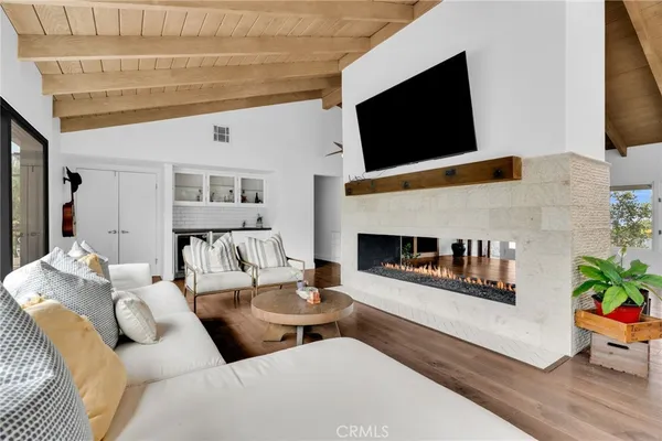 a view of a livingroom with wooden floor and chair
