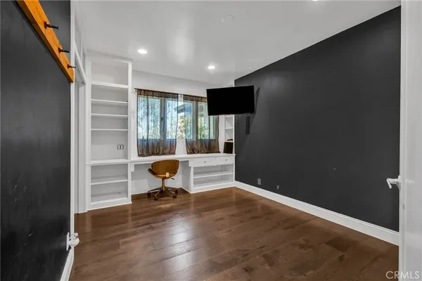 a kitchen with refrigerator and cabinets