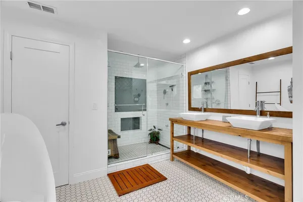 a kitchen with stainless steel appliances granite countertop a table chairs sink refrigerator and cabinets