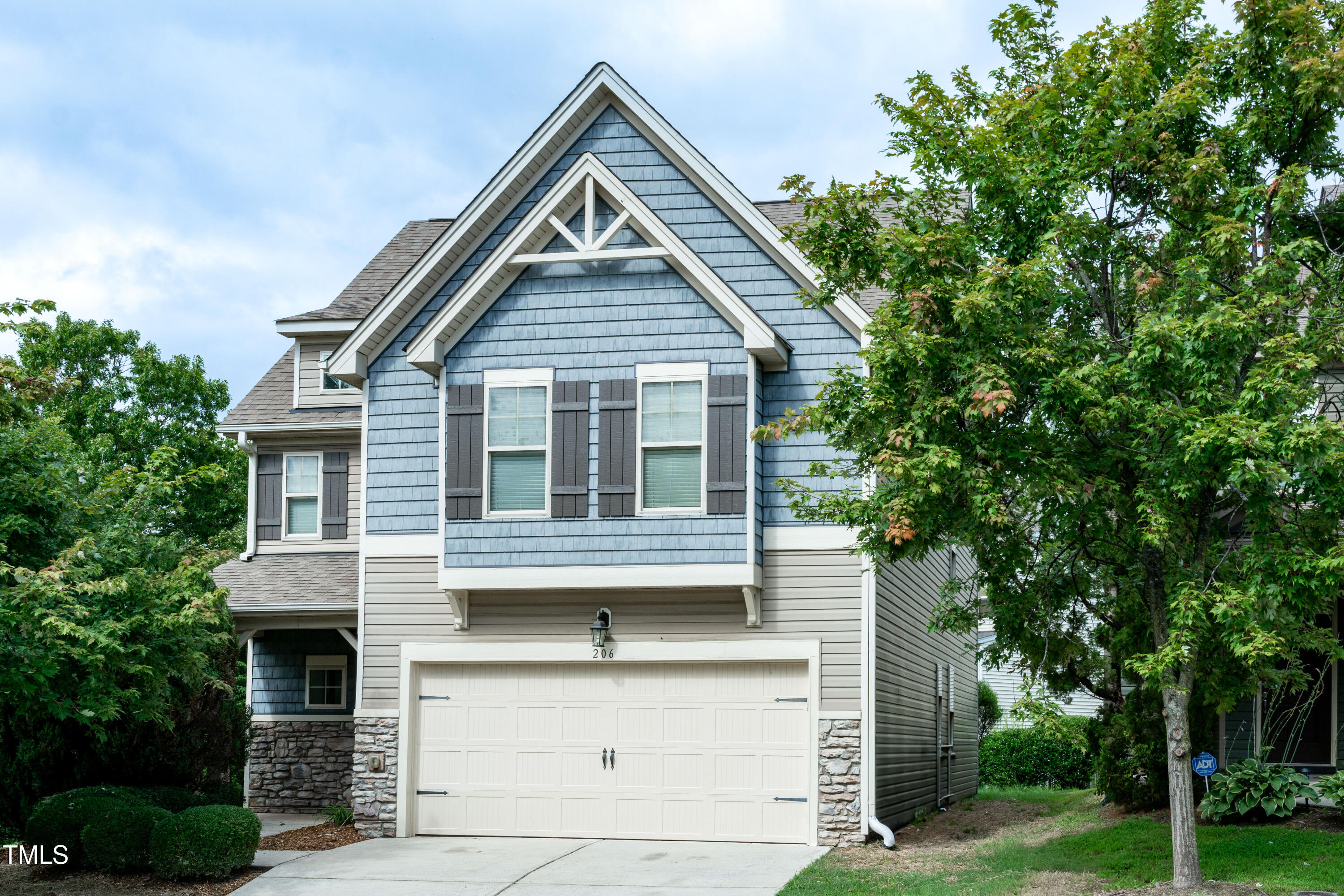 206 Roundhouse Lane Morrisville, NC 27560 - Photo 1 of 42 a front view of a house with a garden