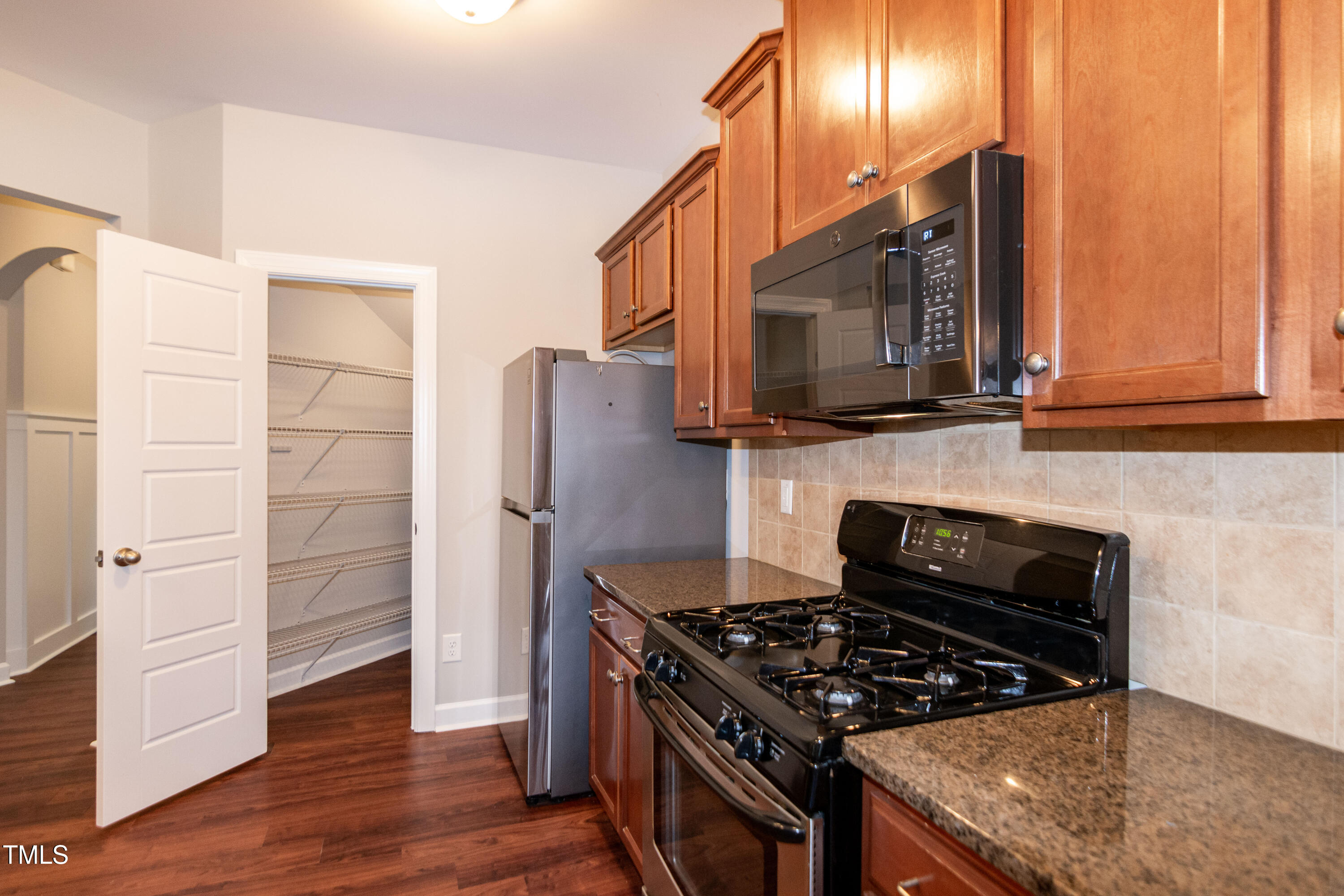 206 Roundhouse Lane Morrisville, NC 27560 - Photo 11 of 42 a kitchen with wooden cabinets and a stove top oven
