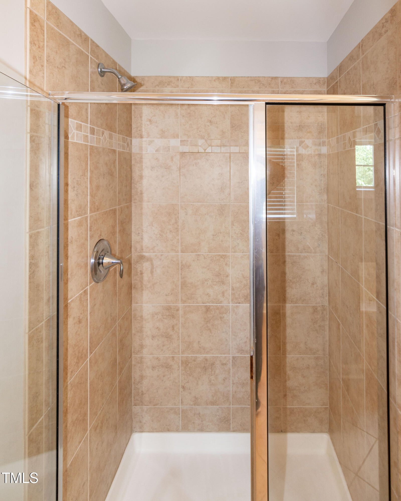 206 Roundhouse Lane Morrisville, NC 27560 - Photo 25 of 42 a bathroom with a glass shower door