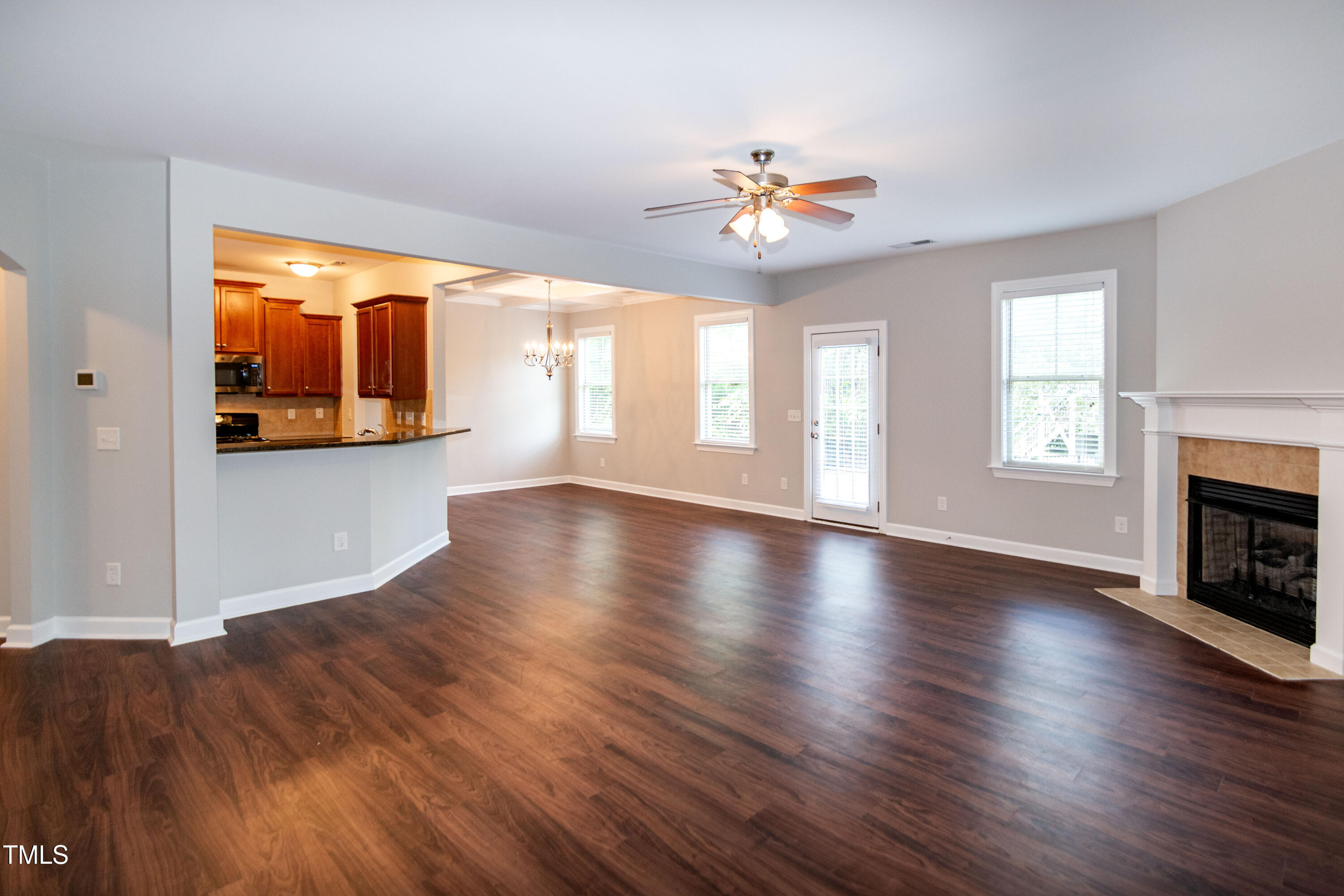 206 Roundhouse Lane Morrisville, NC 27560 - Photo 4 of 42 an empty room with wooden floor chandelier and windows