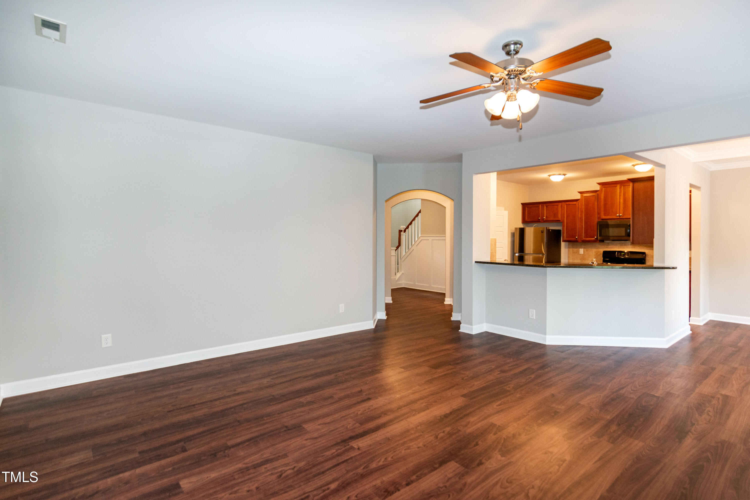 206 Roundhouse Lane Morrisville, NC 27560 - Photo 5 of 42 a view of a kitchen with wooden floor and a ceiling fan
