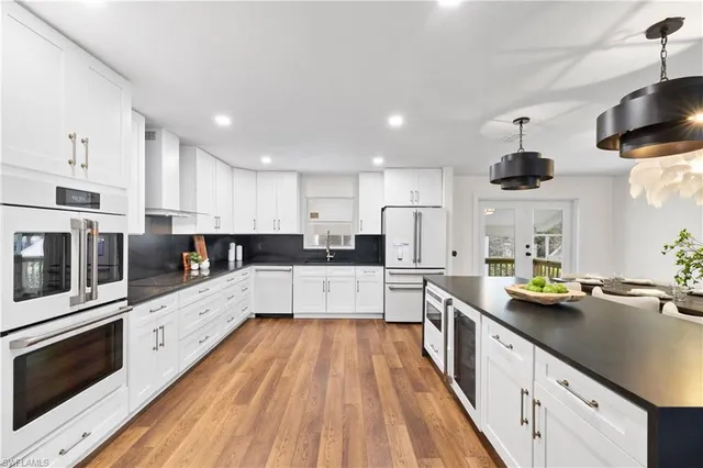 a large kitchen with stainless steel appliances lots of counter top space