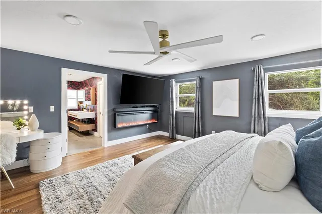 a bedroom with a bed and a dresser with rug