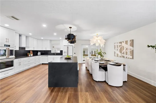 a view of kitchen with sink and wooden floor
