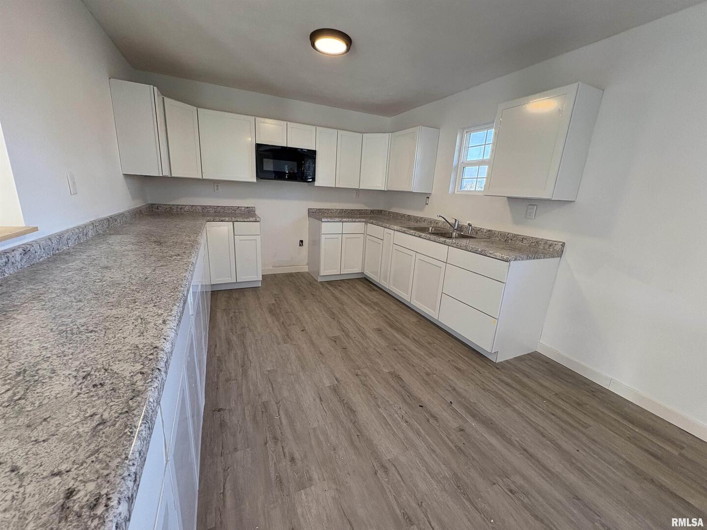 3305 Selmaville Road Salem, IL 62881 - Photo 14 of 17 a kitchen with granite countertop a stove top oven a sink dishwasher and a refrigerator with wooden floor