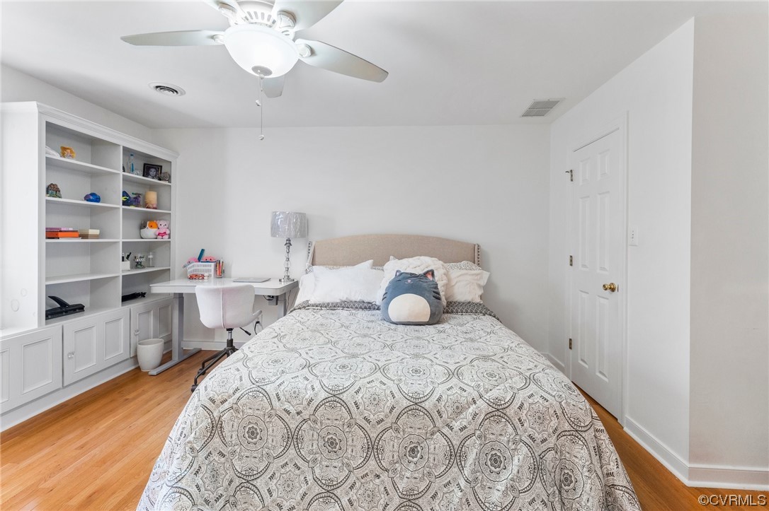 3430 Robious Forest Way Midlothian, VA 23113 - Photo 30 of 50 a bedroom with a bed and a bookshelf with wooden floor