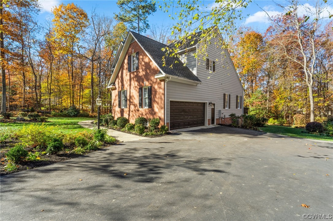 3430 Robious Forest Way Midlothian, VA 23113 - Photo 42 of 50 a front view of a house with a yard and a garage