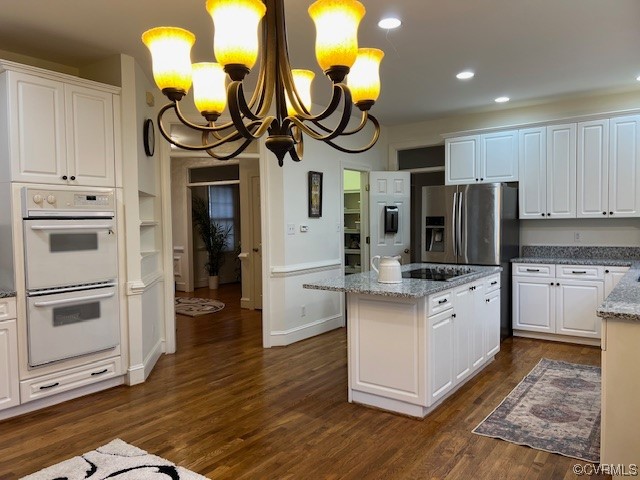 3430 Robious Forest Way Midlothian, VA 23113 - Photo 48 of 50 a kitchen with stainless steel appliances granite countertop a stove and white cabinets with wooden floor