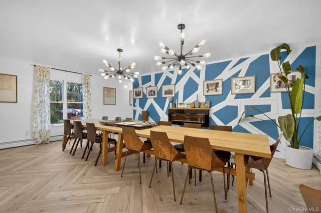 a view of a dining room with furniture and chandelier