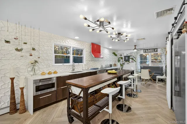 a view of a dining room with furniture and chandelier