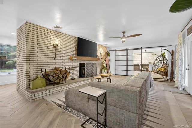 a living room with furniture a fireplace and a flat screen tv