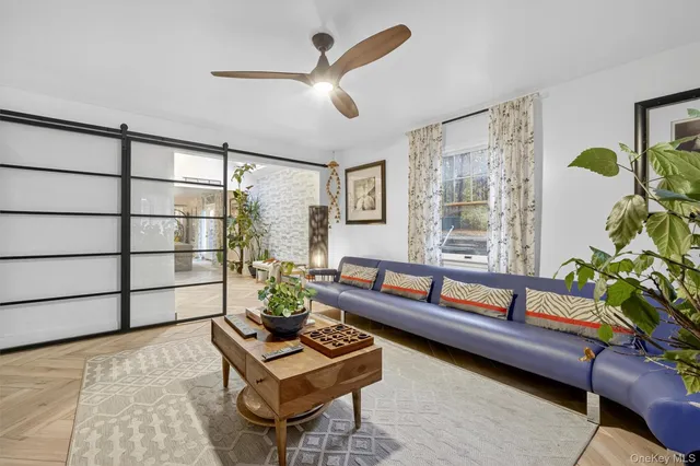 a living room with furniture and a potted plant