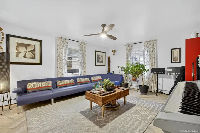 a living room with furniture and a potted plant