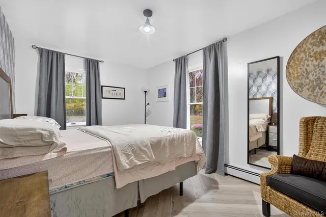 a bedroom with a bed couch and a window