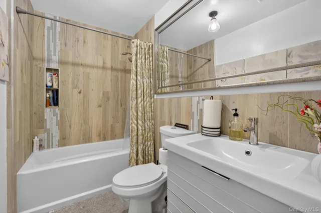 a bathroom with a sink a toilet and a bathtub
