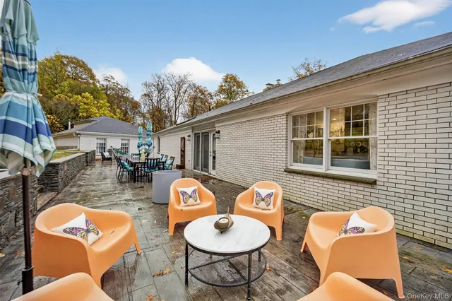 a backyard of a house with wooden floor a fire pit and outdoor seating