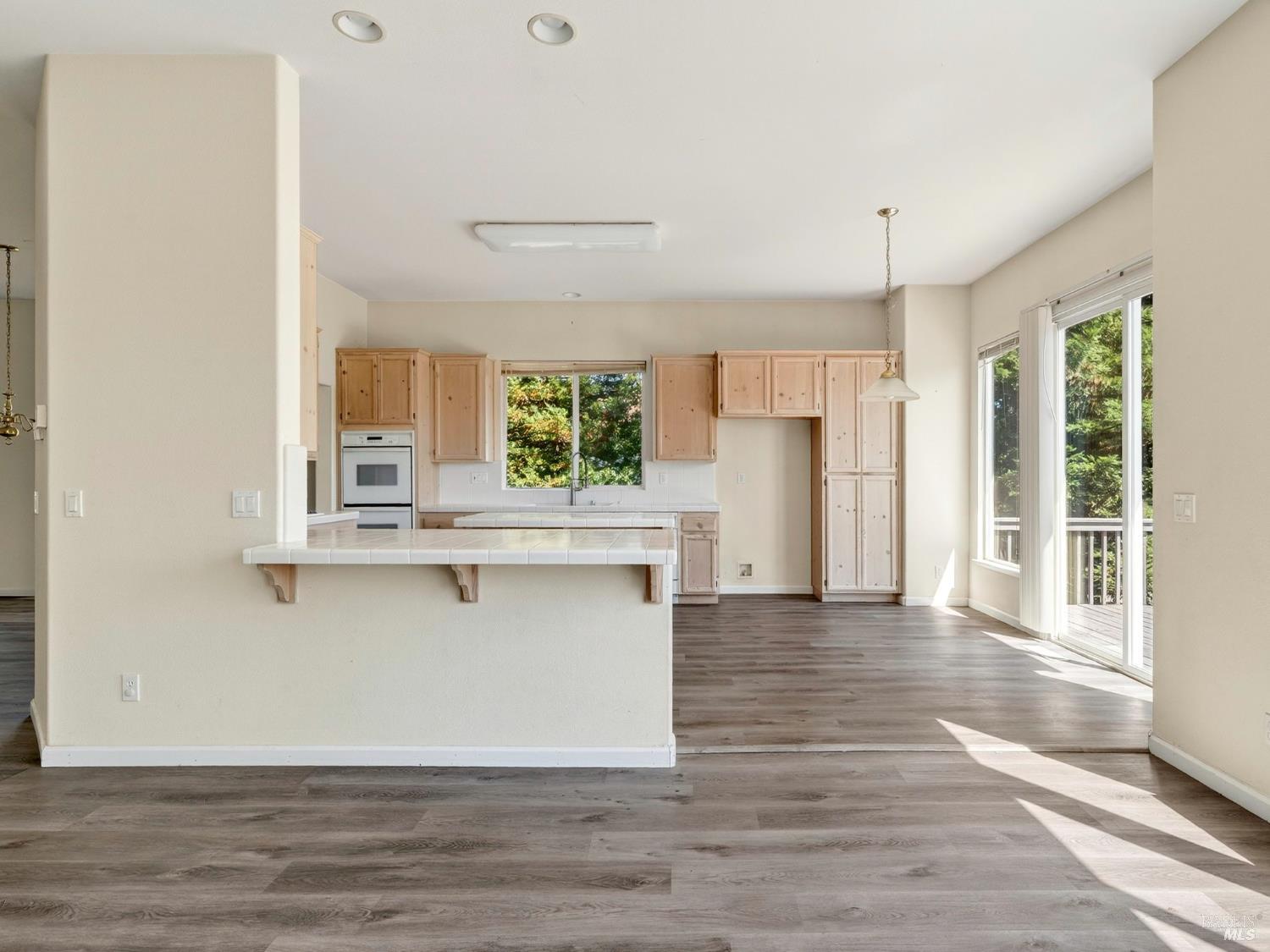 5794 Owl Hill Avenue Santa Rosa, CA 95409 - Photo 15 of 56 a view of an empty room with wooden floor and a window