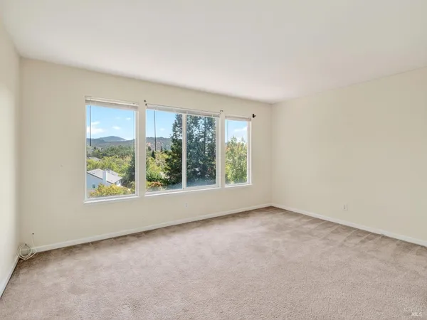 an empty room with a empty space and windows