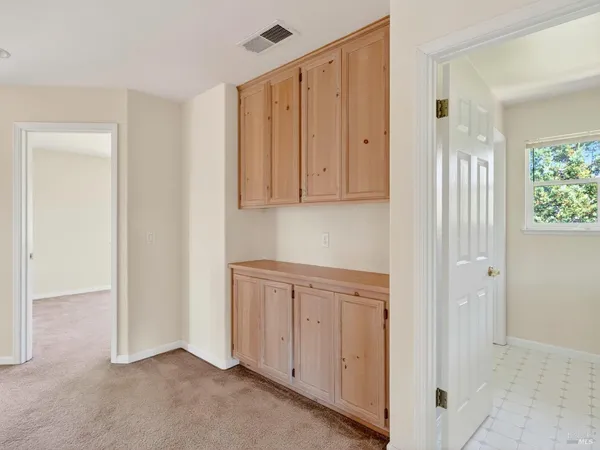 an empty room with windows and closet
