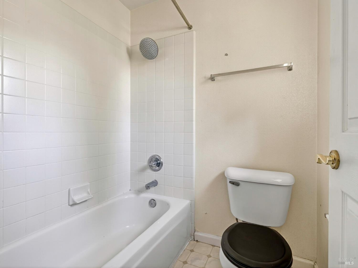 5794 Owl Hill Avenue Santa Rosa, CA 95409 - Photo 36 of 56 a white toilet sitting next to a bath tub and a shower