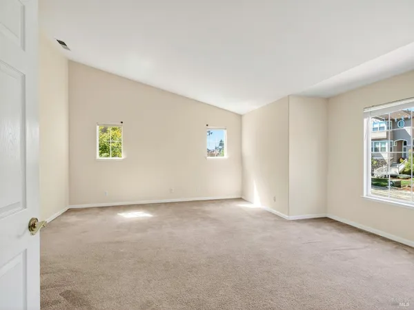 a view of a hallway with white walls and wooden floor