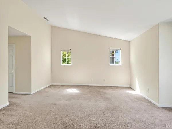 a large white kitchen with a sink and dishwasher next to a window