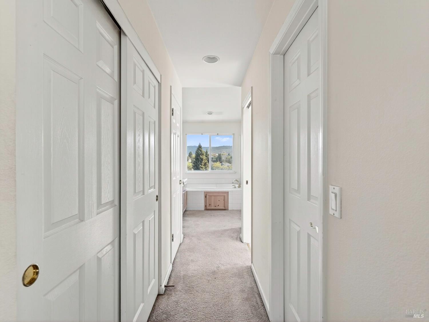 5794 Owl Hill Avenue Santa Rosa, CA 95409 - Photo 43 of 56 a view of a hallway with white walls and wooden floor