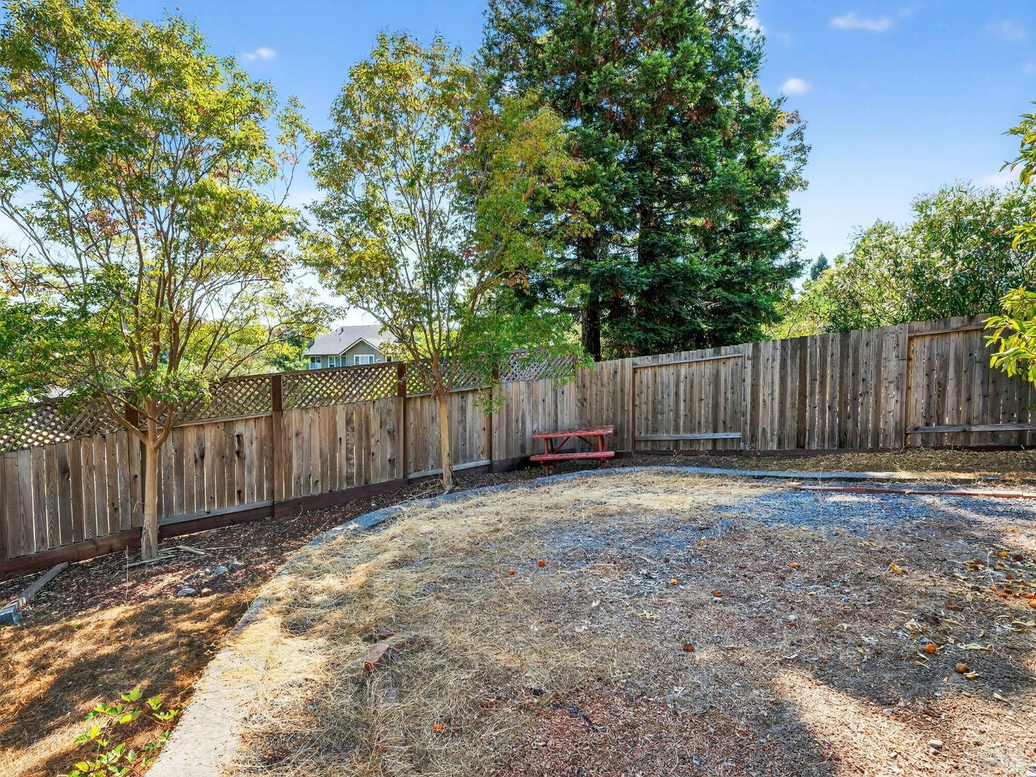 5794 Owl Hill Avenue Santa Rosa, CA 95409 - Photo 55 of 56 a view of a backyard with wooden fence and a large tree