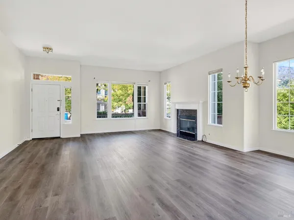 an empty room with windows fire place and windows