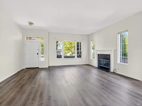 a view of a hallway with wooden floor and stairs