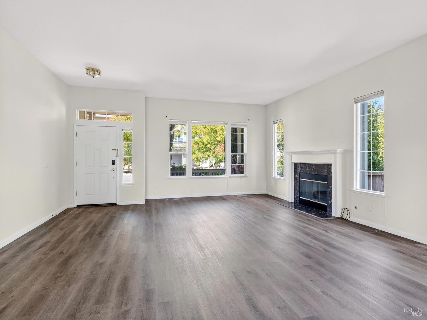 5794 Owl Hill Avenue Santa Rosa, CA 95409 - Photo 7 of 56 an empty room with windows fire place and windows