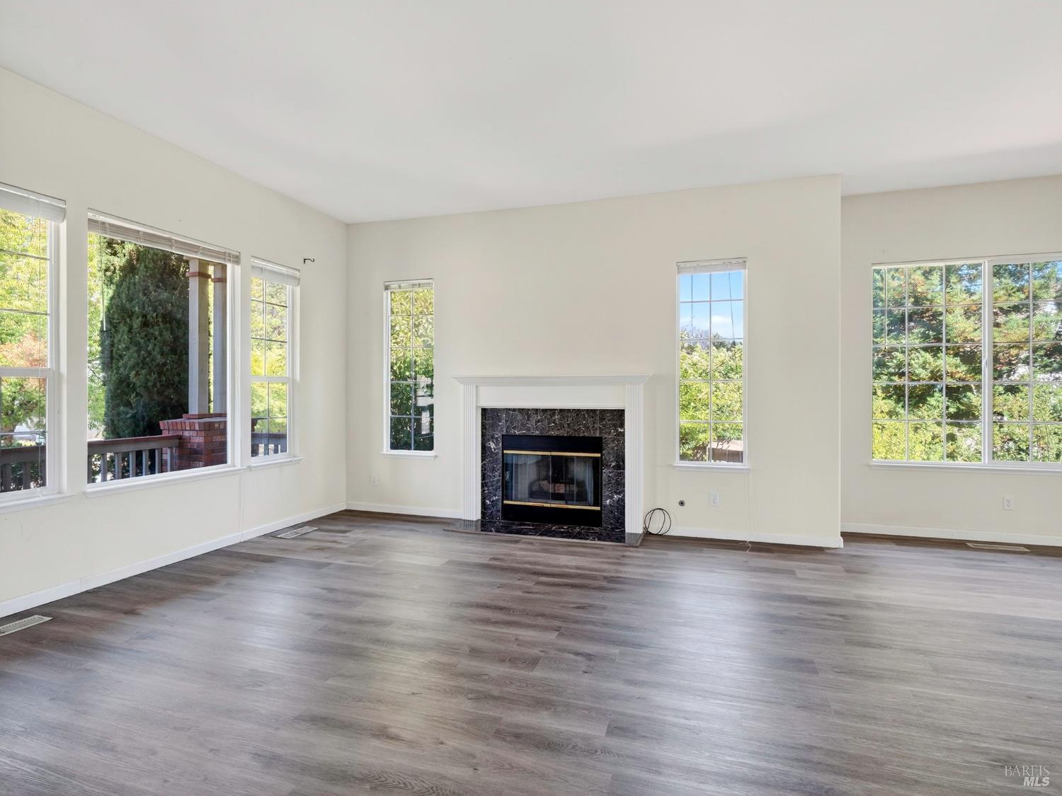 5794 Owl Hill Avenue Santa Rosa, CA 95409 - Photo 9 of 56 a view of an empty room with wooden floor and a window