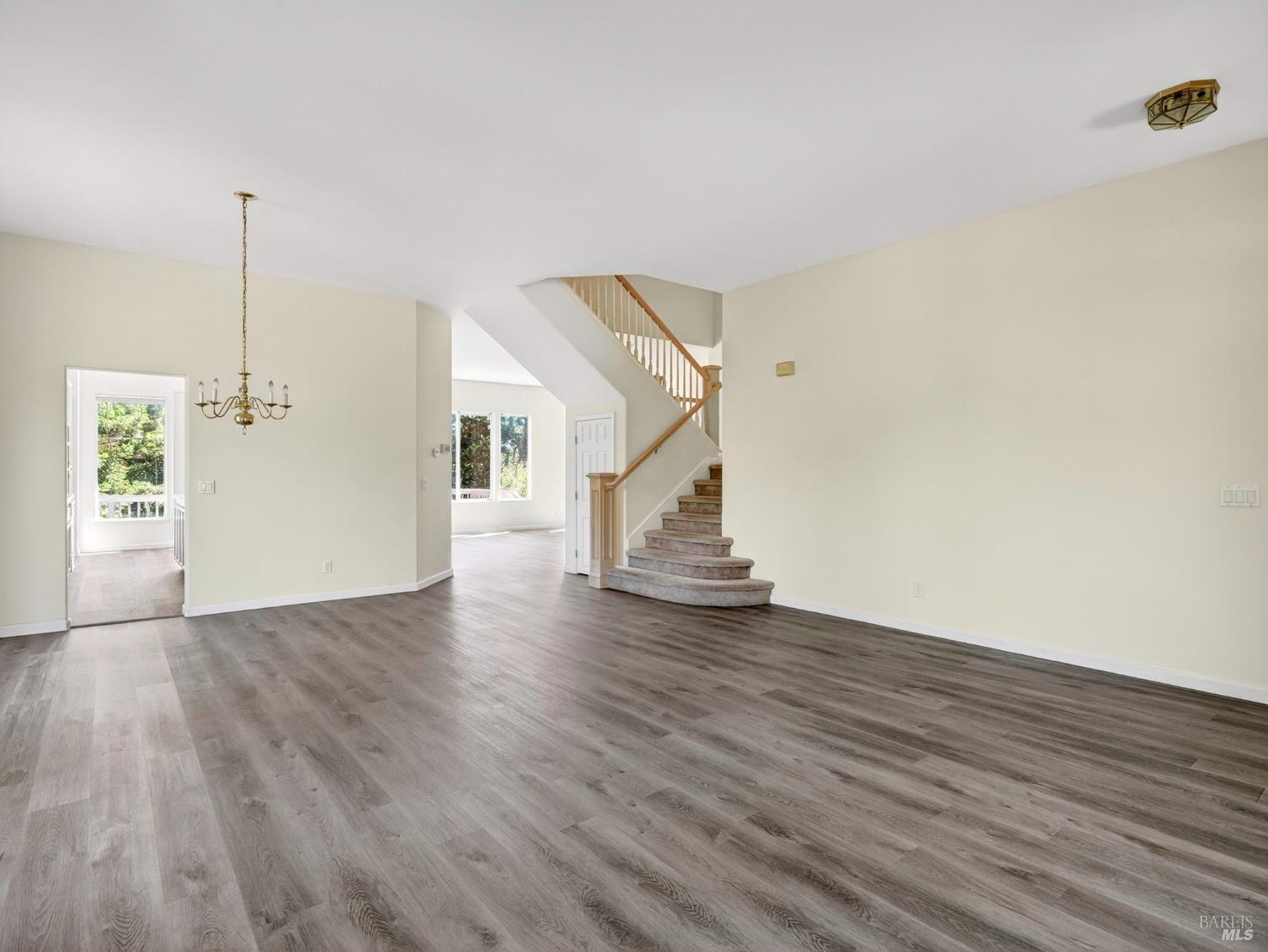 5794 Owl Hill Avenue Santa Rosa, CA 95409 - Photo 10 of 56 a view of an empty room with wooden floor and stairs