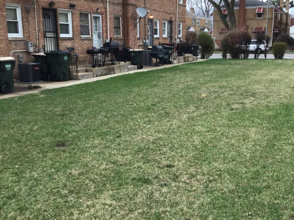 a backyard of a house with yard and outdoor seating