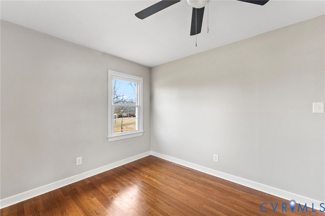 159 2nd Street Appomattox, VA 24522 - Photo 21 of 30 an empty room with wooden floor and windows