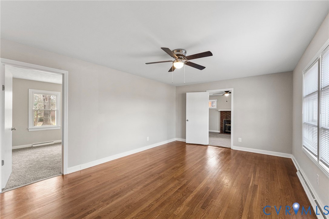 159 2nd Street Appomattox, VA 24522 - Photo 3 of 30 an empty room with wooden floor and windows