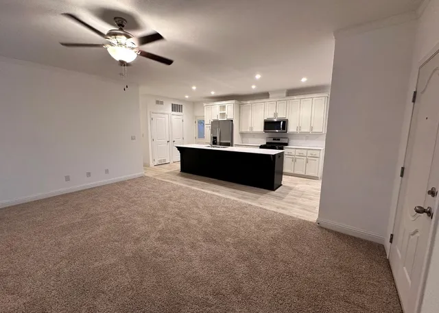 a view of kitchen and kitchen with stainless steel appliances