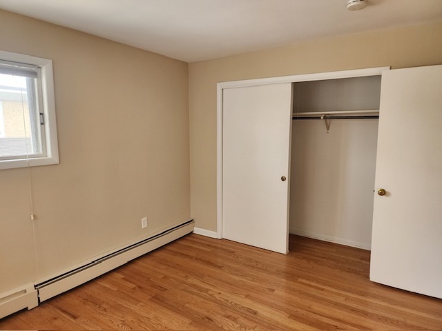 2939 South 13th Avenue, Unit 2N Broadview, IL 60155 - Photo 12 of 18 a view of an empty room with wooden floor and closet