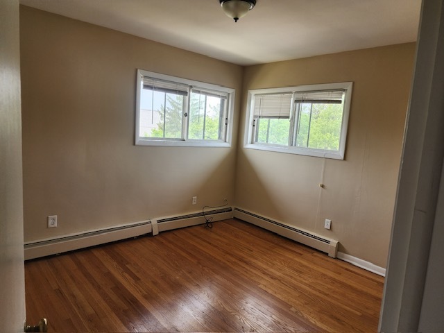2939 South 13th Avenue, Unit 2N Broadview, IL 60155 - Photo 13 of 18 an empty room with wooden floor and windows