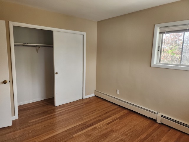 2939 South 13th Avenue, Unit 2N Broadview, IL 60155 - Photo 14 of 18 an empty room with wooden floor and windows