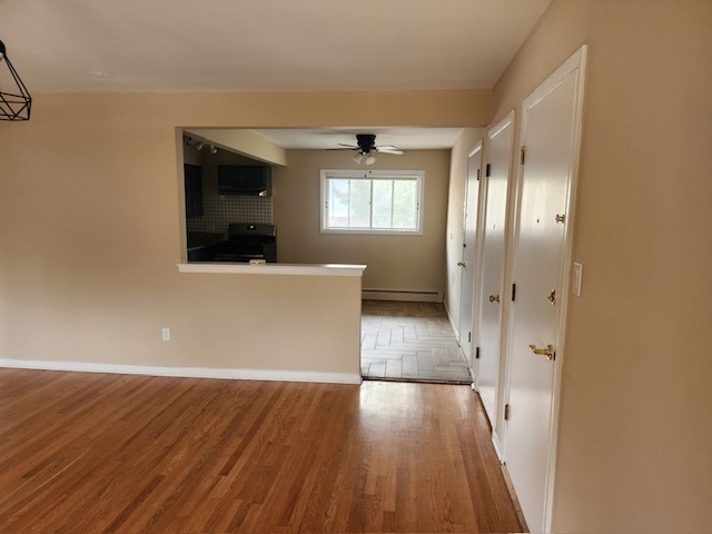 2939 South 13th Avenue, Unit 2N Broadview, IL 60155 - Photo 5 of 18 wooden floor in an empty room with a window