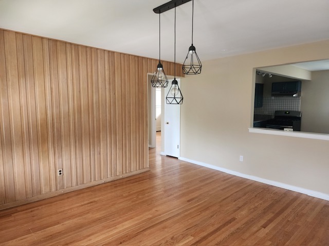 2939 South 13th Avenue, Unit 2N Broadview, IL 60155 - Photo 6 of 18 a view of a kitchen with wooden floor and a ceiling fan