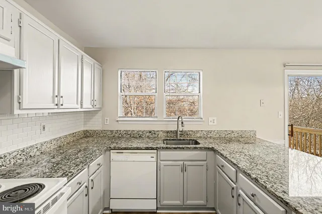 a kitchen with granite countertop white cabinets and a granite counter tops