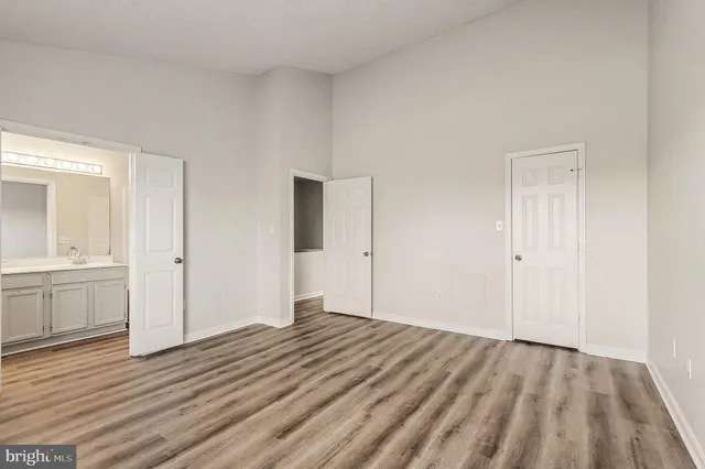 a view of a room with wooden floor and window