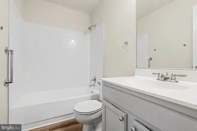a bathroom with a sink toilet vanity and shower